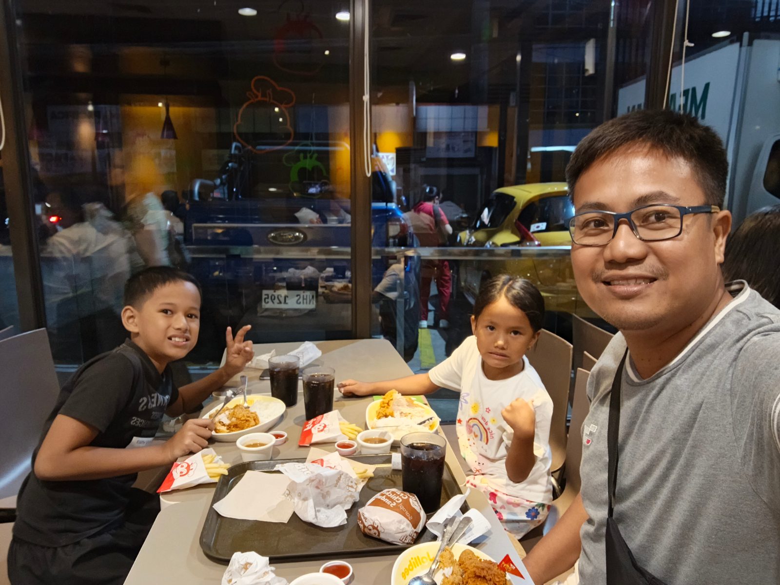 A group of people seated together at a restaurant table sharing a meal.