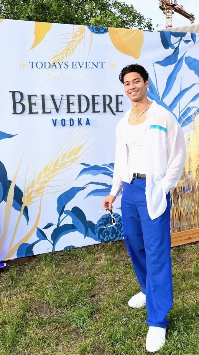 A person in formal attire at an upscale evening event with Belvedere Vodka branding visible.