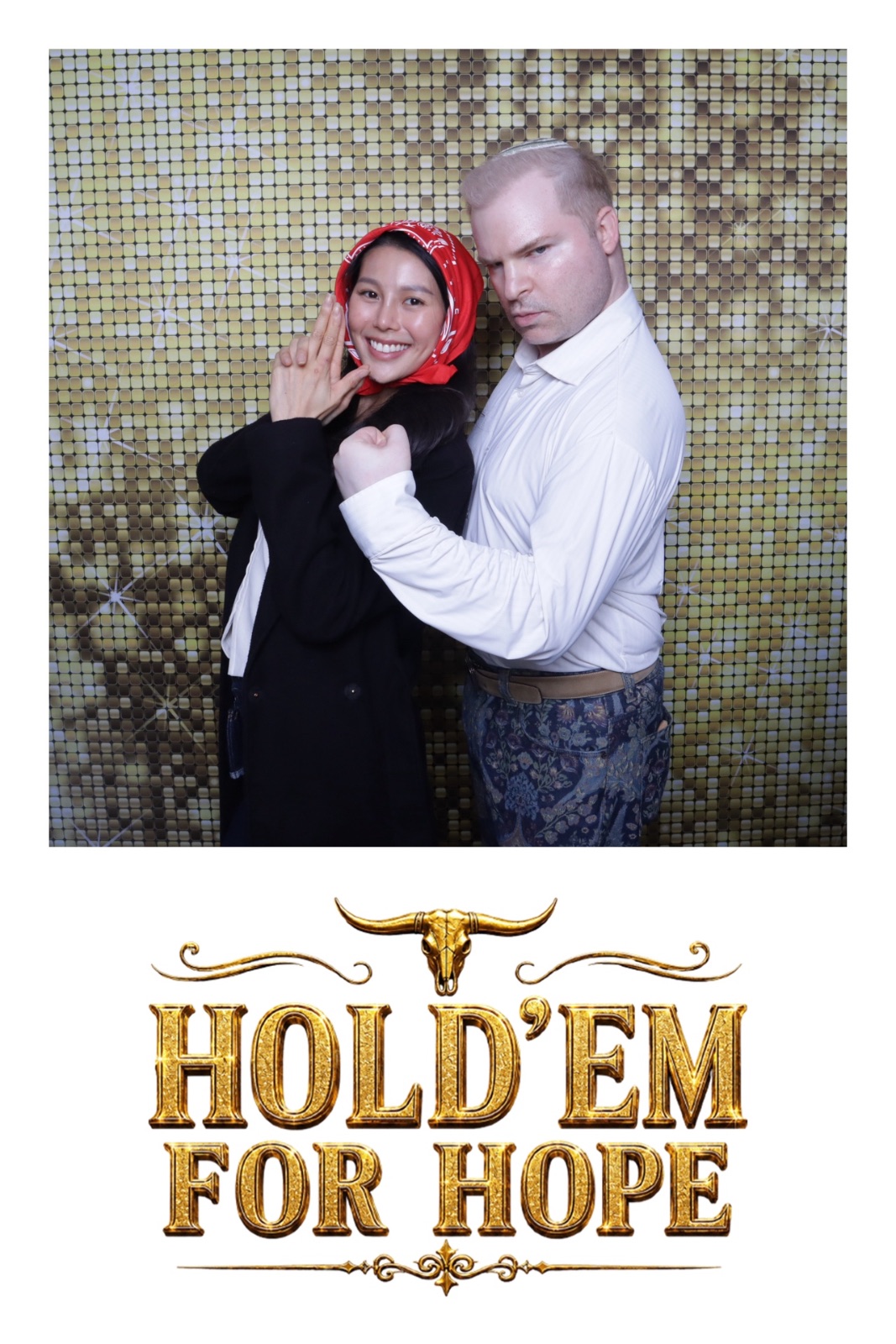 A couple poses together in front of a shimmering gold backdrop at an event.